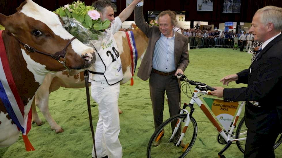 Middenklassekampioene Brook Marie 61 werd tot algemeen kampioene roodbont verkozen. Eigenaar Hans Puttenstein uit Kamperveen ontvangt de felicitaties van Henk Bleker en krijgt van Arie Hamoen een fiets uitgereikt.